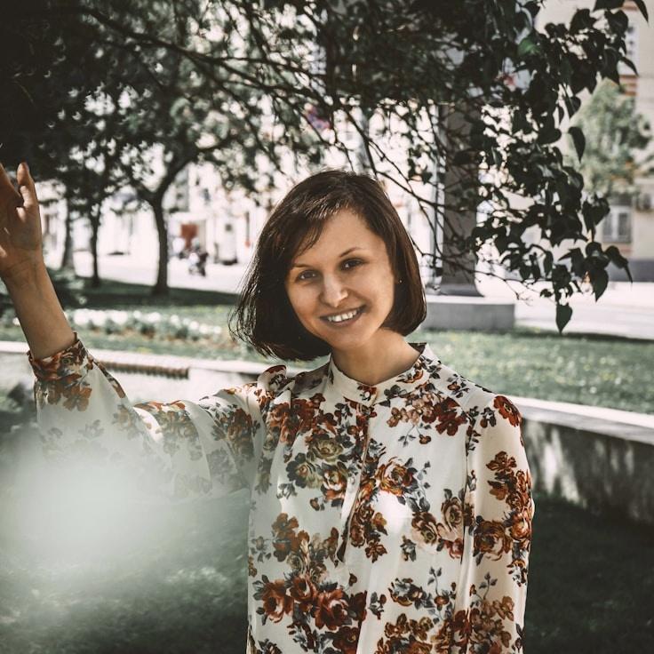 Kaveri Mehta, Lead Design Curator at Peaceful Valley Network, reviewing corporate floral arrangements